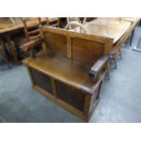 AN EARLY TWENTIETH CENTURY OAK MONKS BENCH WITH LIFT UP SEAT