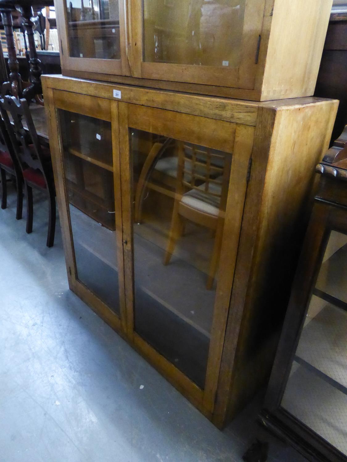 AN OAK DWARF BOOKCASE, ENCLOSED BY TWO GLAZED DOORS