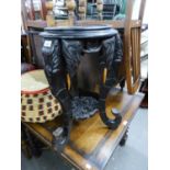 AN INDIAN CARVED DARK STAINED ELEPHANT LEGGED TABLE/STAND