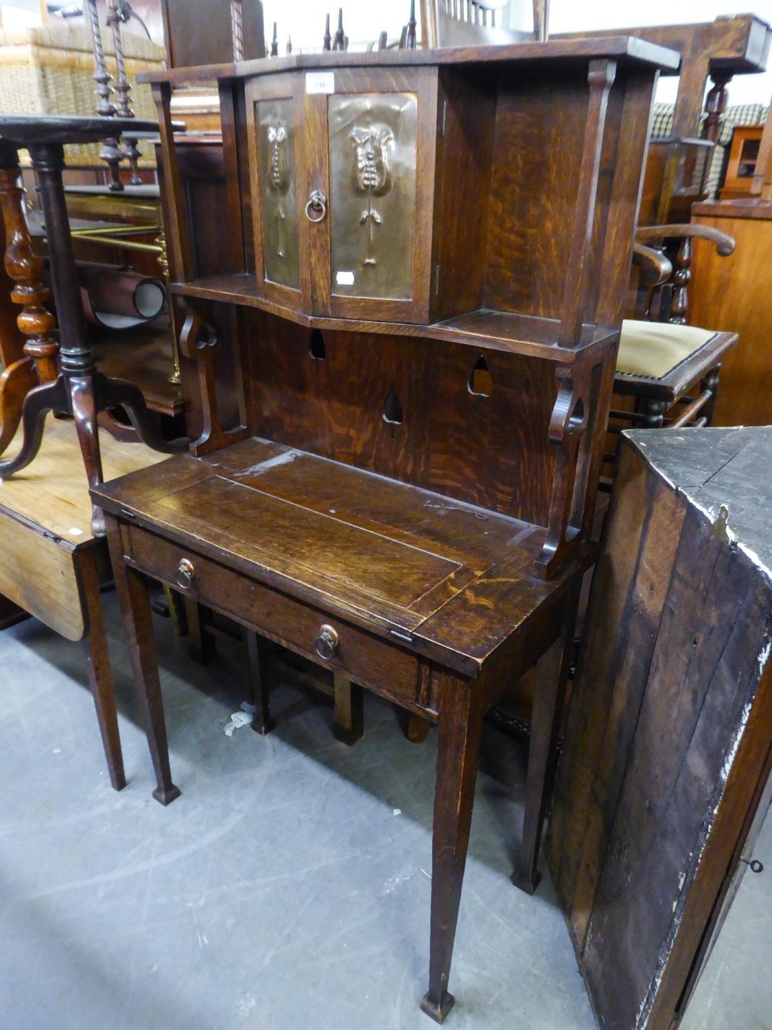 OAK ARTS AND CRAFTS BUREAU WITH FOLDING WRITING TOP, TWO COPPER EMBOSSED PANEL DOORS