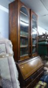 A MAHOGANY BUREAU BOOKCASE, THE VICTORIAN SUPERSTRUCTURE BOOKCASE ENCLOSED BY TWO GLAZED DOORS,