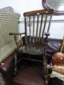 A STAINED HARDWOOD RAIL BACK ROCKING CHAIR