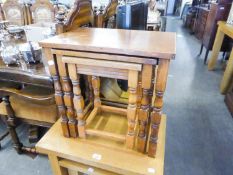 AN OAK NEST OF THREE OBLONG COFFEE TABLES, ON TURNED AND SQUARE LEGS