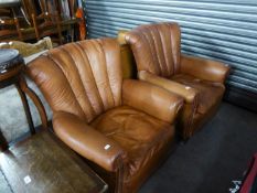 A PAIR OF MID-TAN HIDE LOUNGE ARMCHAIRS, WITH FIVE PANEL FAN SHAPED BACKS, LOOSE SEAT CUSHIONS, ON