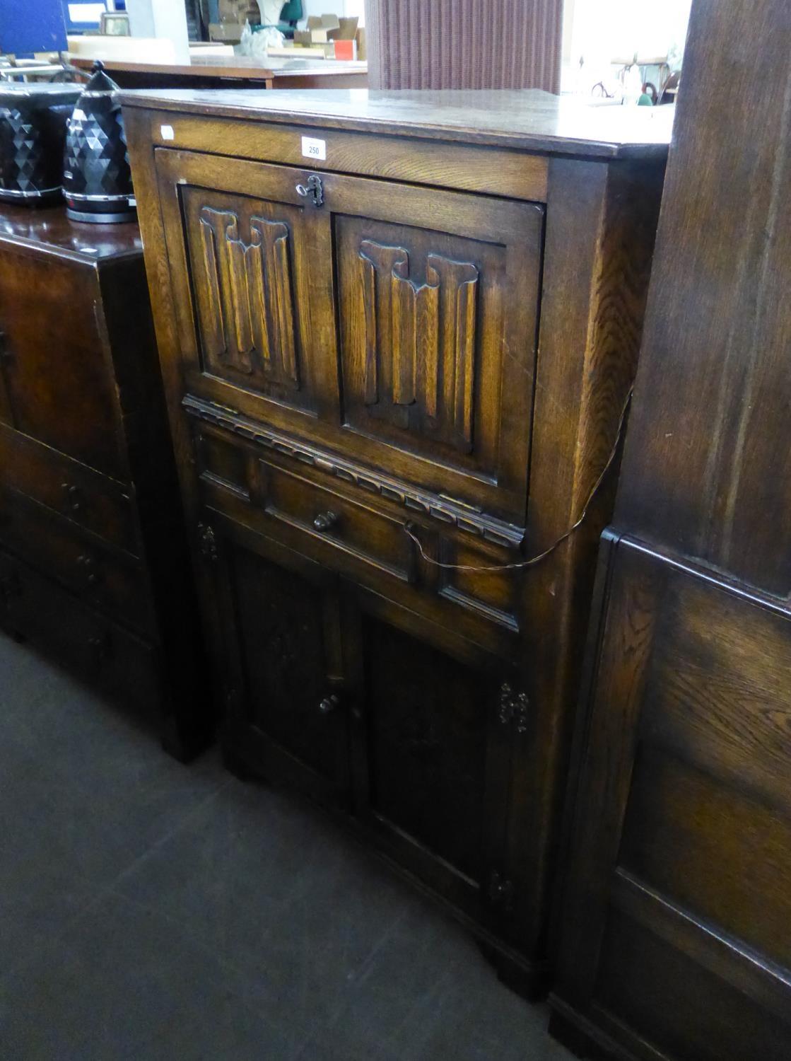 PRIORY STYLE LINEN FOLD CARVED OAK CORNER COCKTAIL CABINET, WITH FALL FRONT OVER  ONE DRAWER AND A