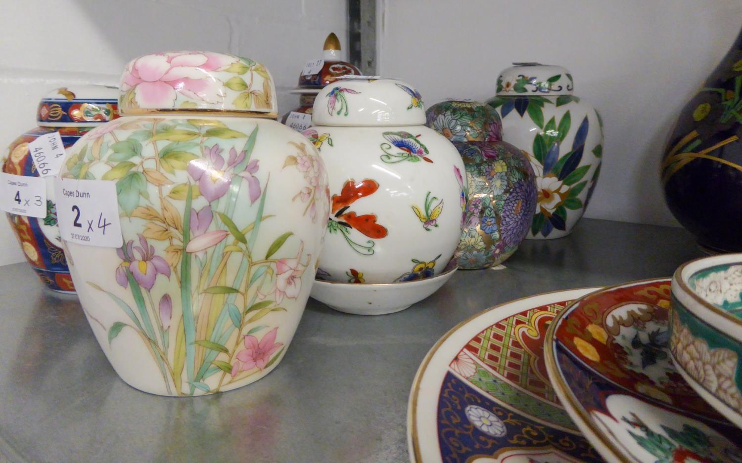 A MODERN JAPANESE PORCELAIN GINGER JAR AND COVER, HAND-PAINTED AUTOUR WITH BIRDS ON A FLOWERING