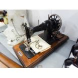 A PORTABLE VICTORIAN SEWING MACHINE IN WOODEN CASE