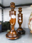 A PAIR OF TURNED OAK URN SHAPED CANDLESTICKS