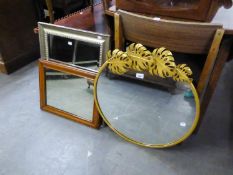 A CIRCULAR MIRROR WITH LARGE GILT METAL LEAF DECORATION ON THE FRAME; ANOTHER MIRROR AND A SMALL