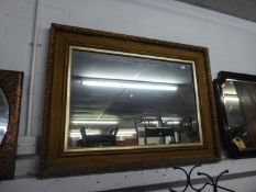 A HEAVY GILT FRAMED OBLONG WALL MIRROR