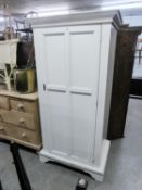 WHITE PAINTED HANG WARDROBE OR STORE CUPBOARD, WITH MOULDED LOOSE CORNICE, FRAMED FOUR PANEL DOOR,
