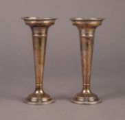 GEORGE V PAIR OF SILVER TRUMPET VASES, of typical form with pierced border and moulded bases, one