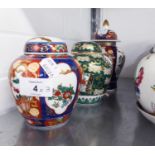 A SUITE OF THREE MODERN JAPANESE PORCELAIN GRADUATED VASES, EACH PAINTED WITH A FLOWERING PLANT ON A