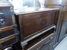 AN OAK BLANKET CHEST WITH APPLIED BLIND FRET CARVING ON STUMP CABRIOLE SUPPORTS, 3' WIDE