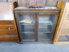 AN OAK BOOKCASE ENCLOSED BY TWO GLAZED DOORS AND A LIGHT WOOD AND PLATE GLASS STYLISH BOOK RACK (2)