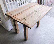 AN OAK FOLD OUT DINING TABLE ON CHUNKY LEGS AND A SET OF 3 MATCHING DINING CHAIRS