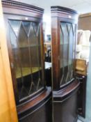 A PAIR OF MAHOGANY REPRODUCTION INLAID CORNER CABINETS AND A MAHOGANY FRAMED MIRROR  (3)