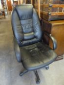 AN EXECUTIVE BLACK HIDE REVOLVING HIGH BACKED OFFICE ARMCHAIR, ON BLACK FIVE SPUR BASE WITH CASTORS