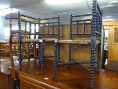 A PAIR OF NINETEENTH CENTURY EBONISED AND BOBBIN TURNED CORNER CHAIRS, WITH RUSH SEATS