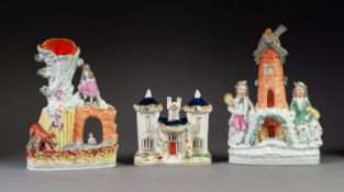 NINETEENTH CENTURY STAFFORDSHIRE POTTERY COTTAGE, with twin turrets, on an oval, gilt lined base,