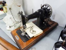 A PORTABLE VICTORIAN SEWING MACHINE IN WOODEN CASE