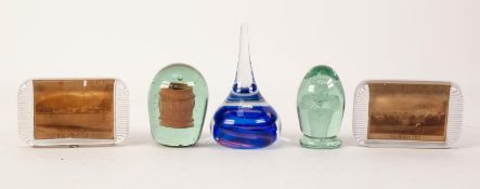 FIVE VICTORIAN AND LATER GLASS PAPERWEIGHTS, comprising: TWO GREEN EXAMPLES, one with flower in