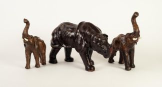 LEATHER COVERED MODEL OF A RHINOCEROS, 8? (20.3cm) high, together with a SIMILAR, GRADUATED PAIR