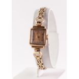 a 9ct GOLD CASED HELVETIA LADY'S WRIST WATCH, on gilt metal linked bracelet