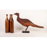 Painted metal model of a pheasant, mounted on a rounded oblong base, 15 ½? (39.3cm) high, together