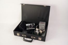 Case containing an OLYMPUS 35 RC ROLL FILM CAMERA with OLYMPUS E-ZUIKO LENS, 1: 2.8, f = 42mm, in