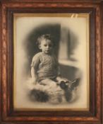 EARLY 20th CENTURY LARGE PHOTOGRAPHIC IMAGE OF A SEATED CHILD, in contemporary oak frame with gilt