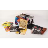 VINYL RECORDS SINGLES. Various 45rpm singles house in a brown carry case. A mixture of genre and