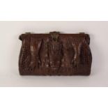 1920s CROCODILE HANDBAG, with short loop handle, brass frame with central locking catch and two