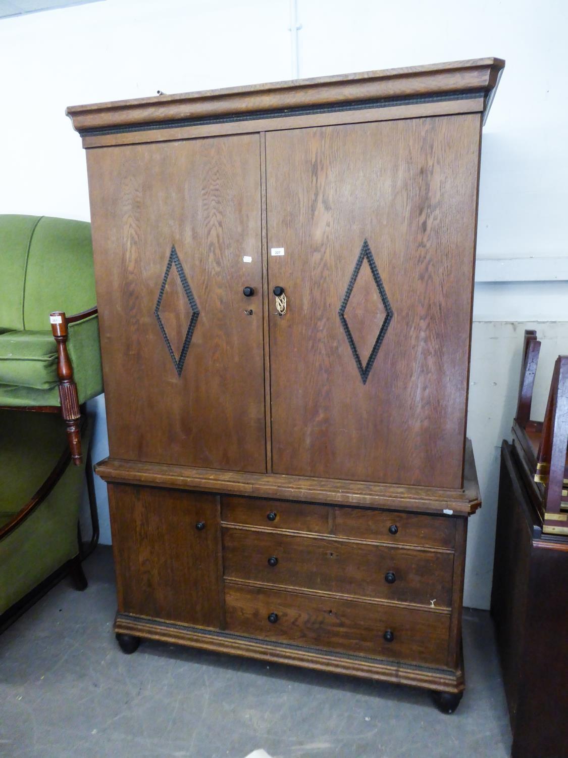 A GOOD QUALITY INTER-WAR YEARS GERMAN OAK TWO PART CABINET, THE UPPER PORTION ENCLOSED WITH TWO