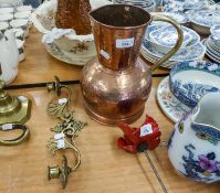 A BRASS CANDLE LIGHT WALL BRACKET, WITH TWO SWINGING BRANCHES AND A LARGE BEATEN COPPER FLAGON (2)