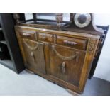 1950's CARVED OAK ENCLOSED SIDEBOARD, WITH THREE DRAWERS OVER A CUPBOARD WITH TWO DOORS