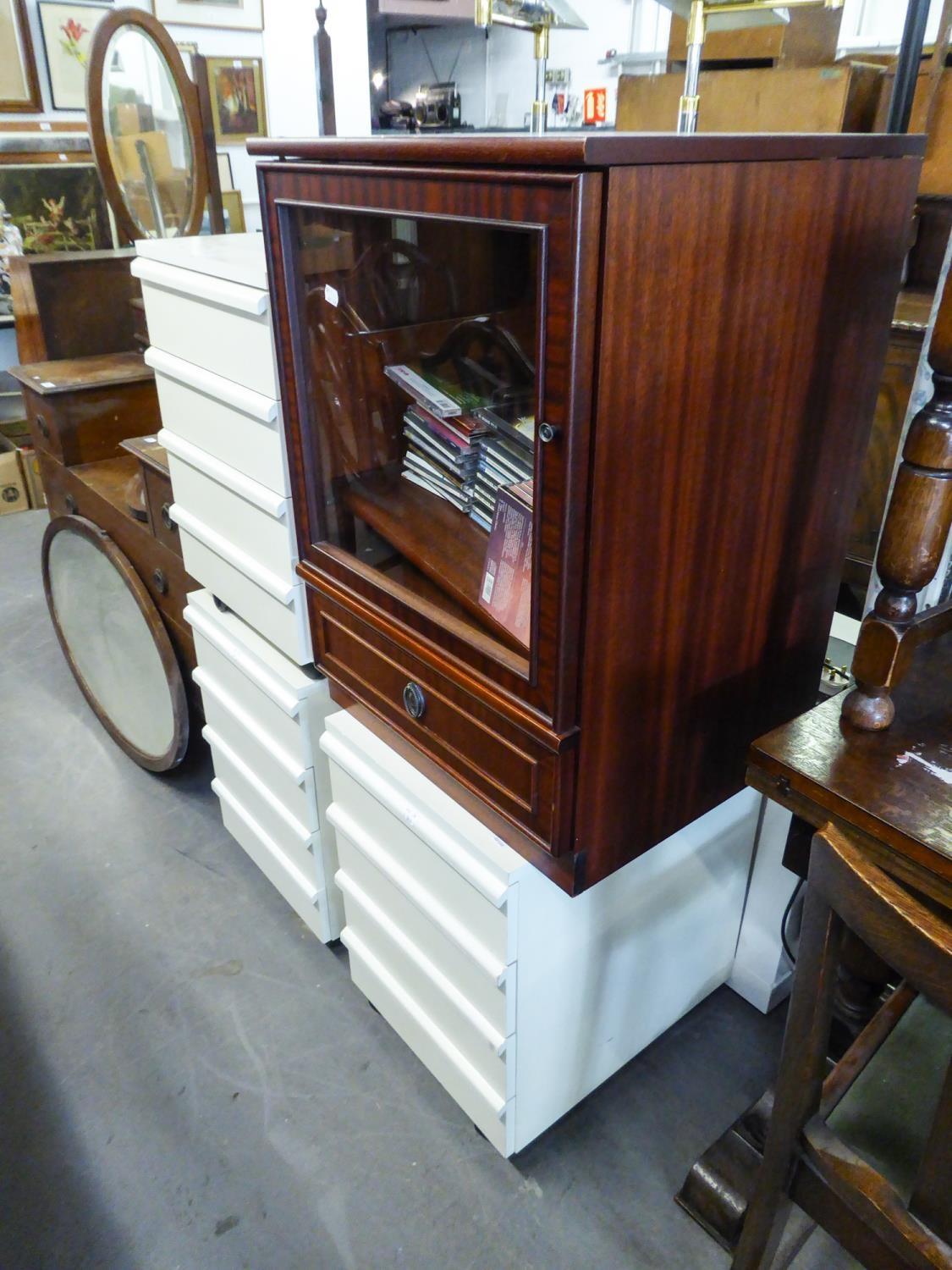 THREE WHITE FINISH FOUR DRAWER BESIDE CHESTS AND A HI-FI CABINET WITH A SMALL QUANTITY OF CD's