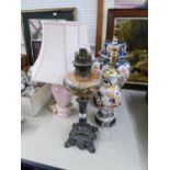 A SMALL LATE VICTORIAN METAL BASE OIL LAMP, WITH GLASS WELL AND FUNNEL, TWO ORIENTAL TABLE LAMPS AND