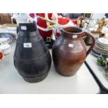 AN ANTIQUE WOODEN AND METAL BANDED PROBABLY CIDER PITCHER AND AN ANTIQUE STONEWARE LARGE JUG (2)