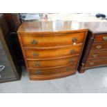 AN INTER-WAR YEARS GERMAN BOW FRONTED CHEST OF FOUR DRAWERS WITH BRASS BACK PLATE HANDLES
