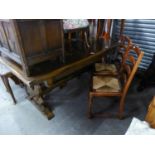 A TWENTIETH CENTURY OAK DRAW-LEAF TRESTLE END DINING TABLE AND SIX DINING CHAIRS