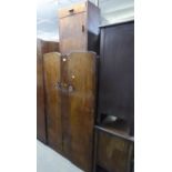 A SMALL OAK TWO DOOR WARDROBE; AN OAK DRESSING CHEST OF THREE DRAWERS WITH FRAMELESS MIRROR ATTACHED