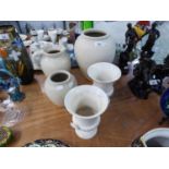 A PAIR OF WEDGWOOD WHITE POTTERY URN SHAPED VASES AND THREE ITEMS OF LOVATTS WHITE POTTERY, VIZ