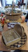 A LARGE CIRCULAR WICKER TRAY, SIX WICKER BASKETS VARIOUS AND A HAT BOX CONTAINING SMALLER BOXES