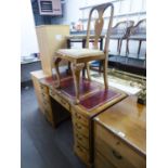 A PALE FIGURED WALNUTWOOD DOUBLE PEDESTAL DESK, WITH NINE DRAWERS WITH RED LEATHER INSETS TO THE