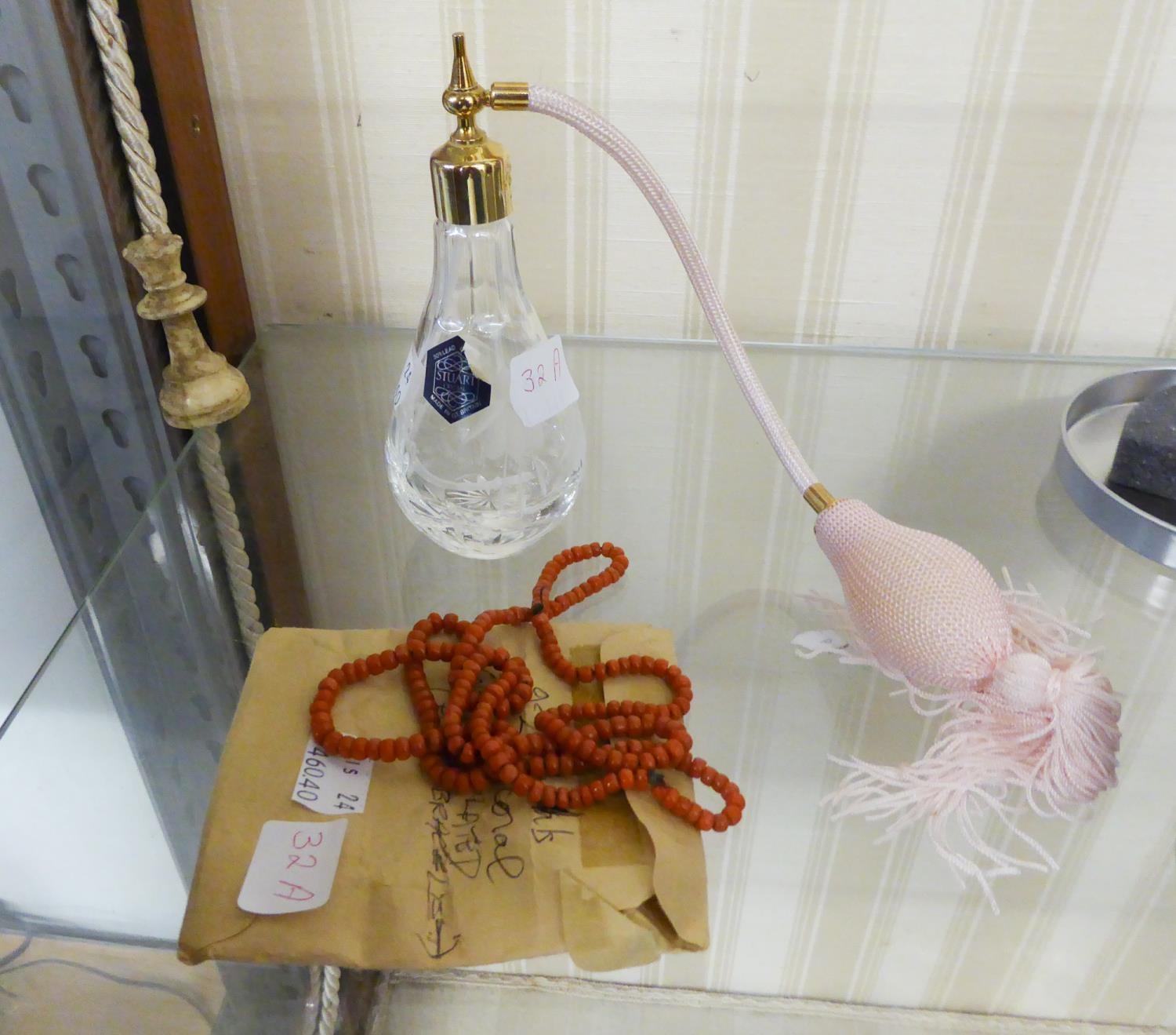 A CONTINUOUS NECKLACE OF UNIFORM CORAL BEADS AND A STUART CRYSTAL PERFUME ATOMISER