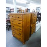 A CONTINENTAL POLISHED HARDWOOD TALL BOY CHEST OF FIVE LONG DRAWERS, ON HEAVY TURNED FEET AND A PAIR