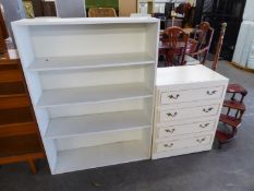 A CREAM CHEST OF FOUR DRAWERS AND A WHITE PAINTED OPEN BOOKCASE (2)