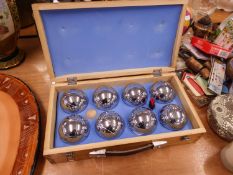 A CHROME PLATED STEEL BOULES SET, IN WOODEN CASE