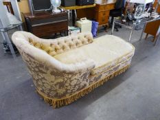 A CHAISE LONGUE WITH CURVED END, COVERED IN GOLD FABRIC